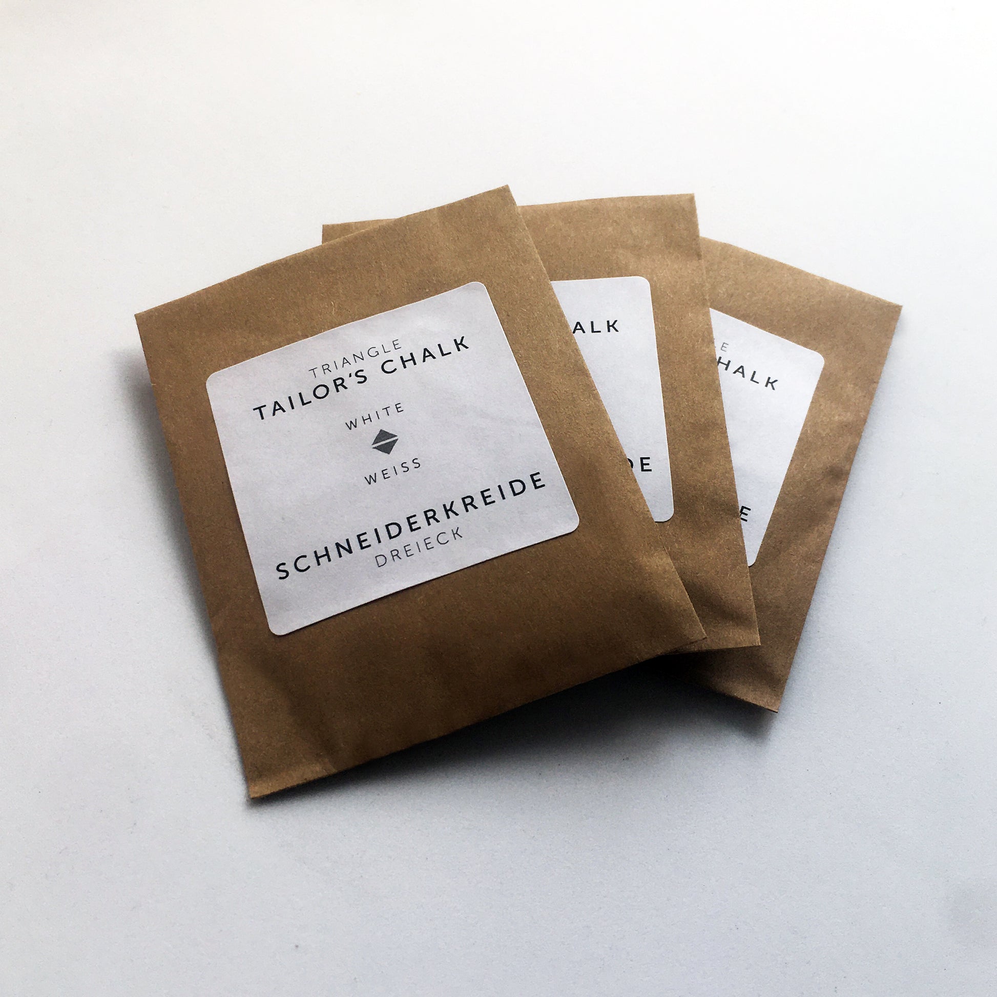 High-quality Japanese tailor’s chalks are revered worldwide by professional tailors for their precision, and smooth performance on fabrics. They are formulated to retain a sharp edge, allowing for precise marking of fine lines, curves, and intricate tailoring patterns. They come in a paper bag. No plastic packaging.