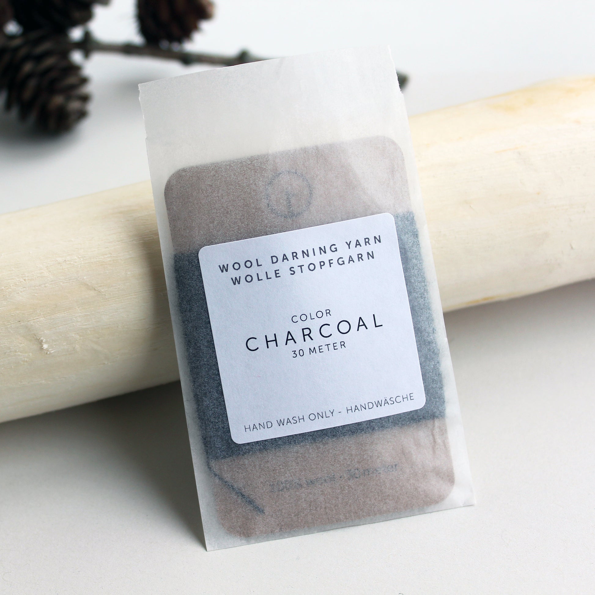 A 30-meter card of 100% wool darning yarn in charcoal (dark grey) colour, neatly wound and ready for mending knit garments. The yarn is packaged in a small, eco-friendly parchment paper bag.
toolly offers darning yarns in 9 essential colours. They are 100% pure wool without any artificial fiber. 30 meter yarn is wound around kraft paper card. Set of 3 colours, 6 colours and a color sample card can be also purchased.