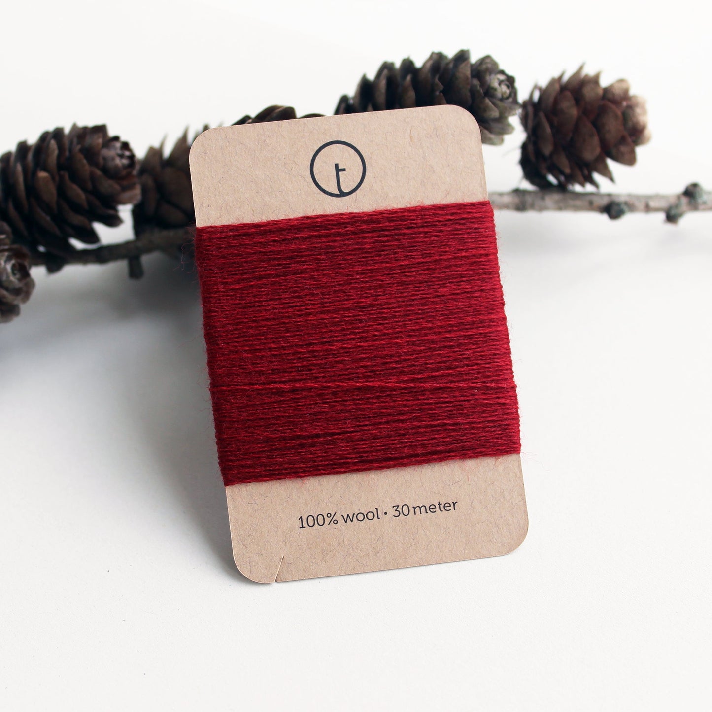 A 30-meter card of 100% wool darning yarn in dark red color neatly wrapped around a labeled rectangular paper card, ideal for repairing knitwear.
toolly offers darning yarns in 9 essential colors. They are 100% pure wool without any artificial fiber. 30 meter yarn is wound around kraft paper card. Set of 3 colors, 7 colors and a color sample card can be also purchased.
