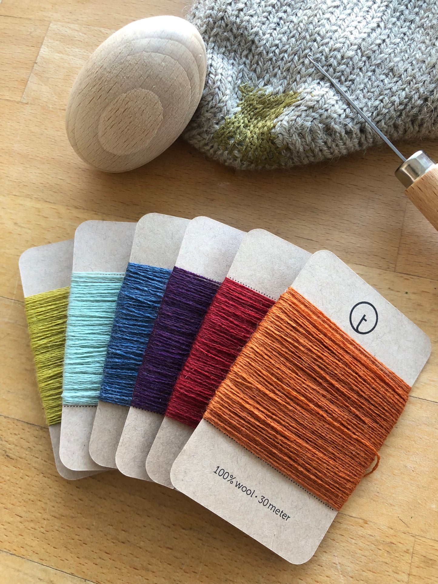 A set of six 30-meter cards of 100% wool fine darning yarn in assorted colourful colours. Ideal for mending socks, sweaters, and other wool garments.