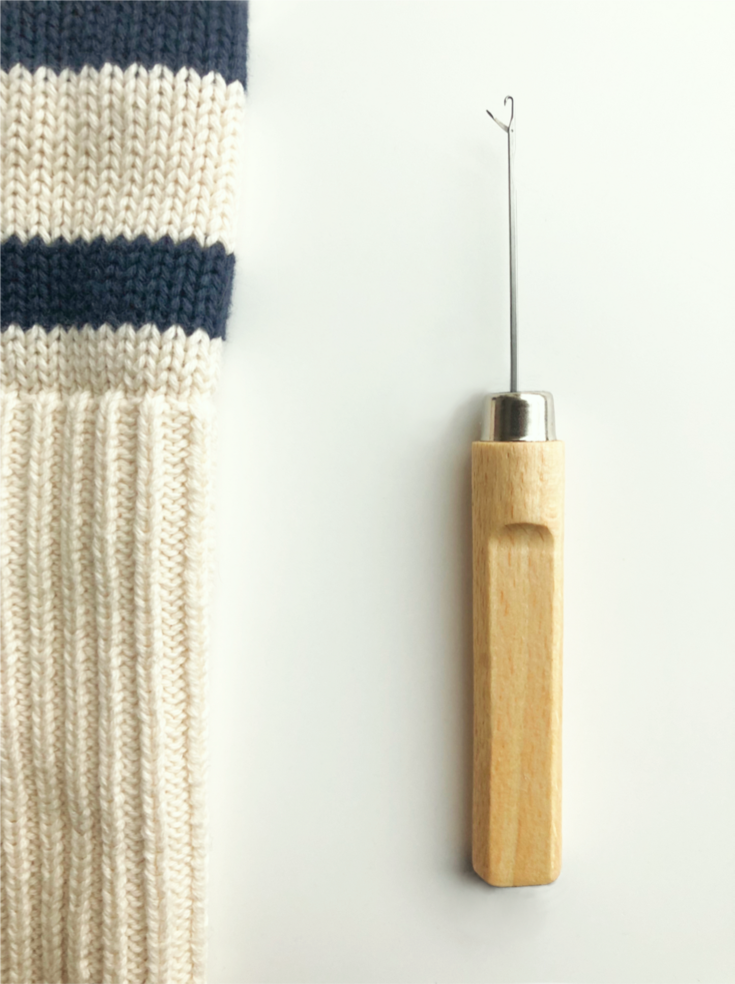 The Ladder Darner, also known as a catching needle, is a specialized tool designed for darning and mending ladders in knitwear such as tights, socks, and sweaters. Its fine, curved hook gently catches and pulls loose or broken threads back into place, making it easy to repair runs and snags in knitted fabrics. Ideal for quick, invisible fixes, this compact needle is a must-have for anyone looking to extend the life of their favourite garments with simple, precise repairs.