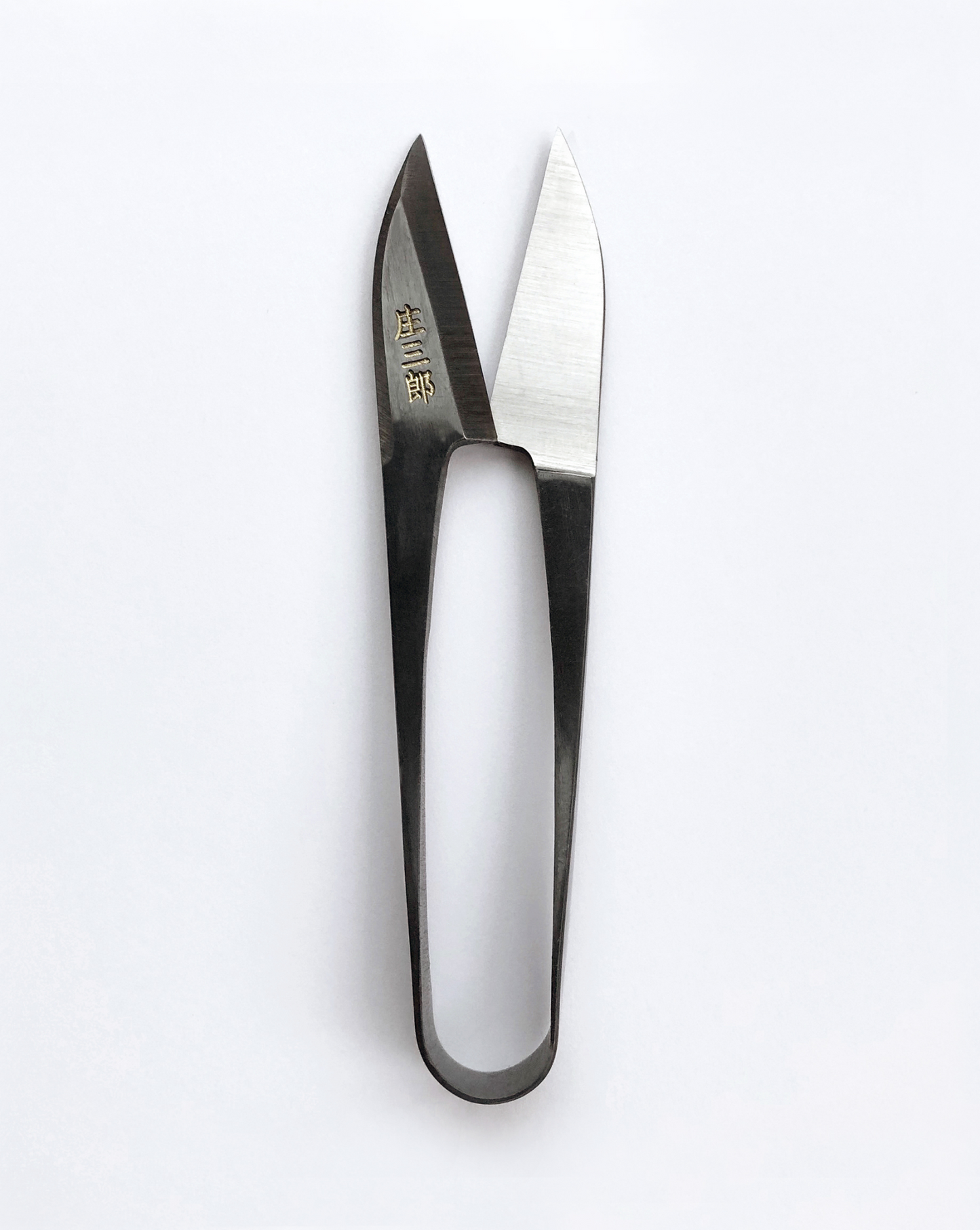 Traditional Japanese U-shaped spring scissors by Shozaburo, made of premium carbon steel; 10.5 cm long, 30 g, beautifully boxed with care guide—ideal for delicate, detailed cutting and thread trimming.