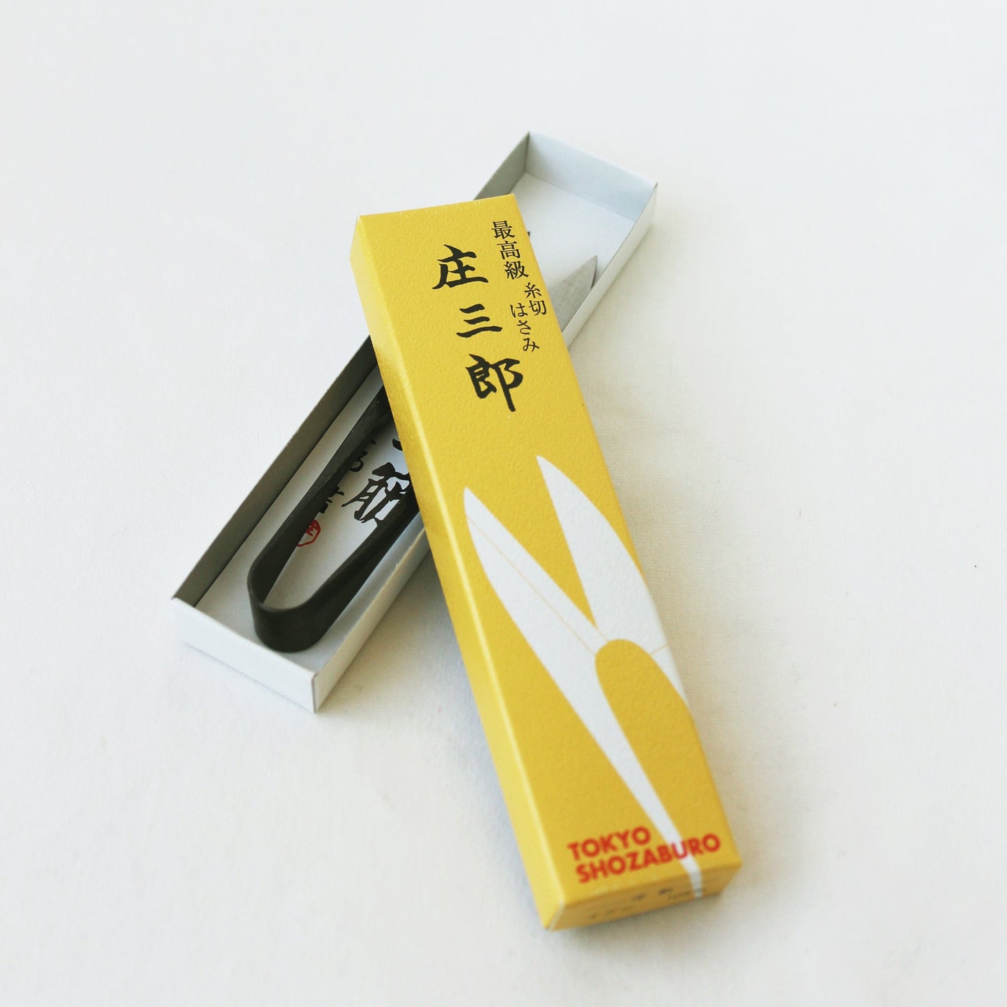 Traditional Japanese U-shaped spring scissors by Shozaburo, made of premium carbon steel; 10.5 cm long, 30 g, beautifully boxed with care guide—ideal for delicate, detailed cutting and thread trimming.