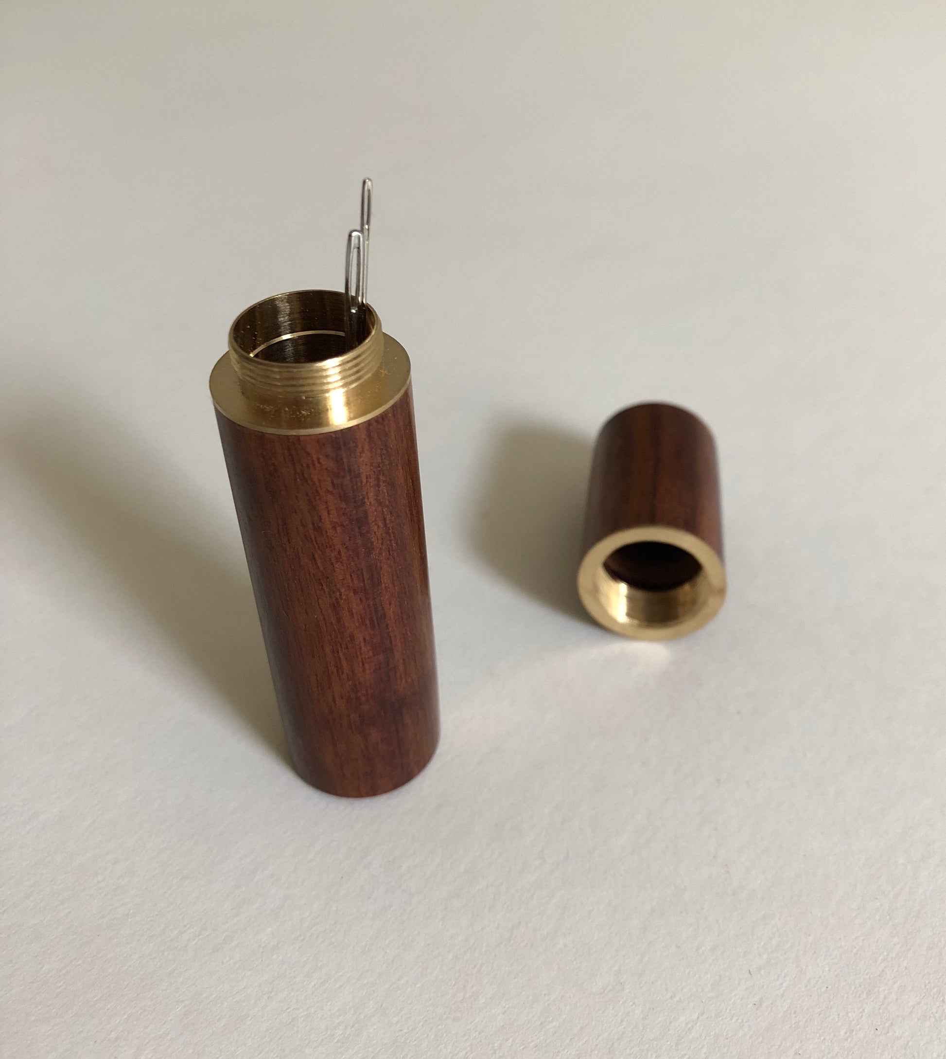 Crafted from natural wood and brass, this needle case is the perfect blend of elegance and practicality for every sewing enthusiast. The secure screw-top lid keeps your needles safely stored, preventing loss and damage. The compact size fits effortlessly into any sewing kit or travel bag, ensuring your needles are always within reach. This needle case is ideal for a variety of needles.