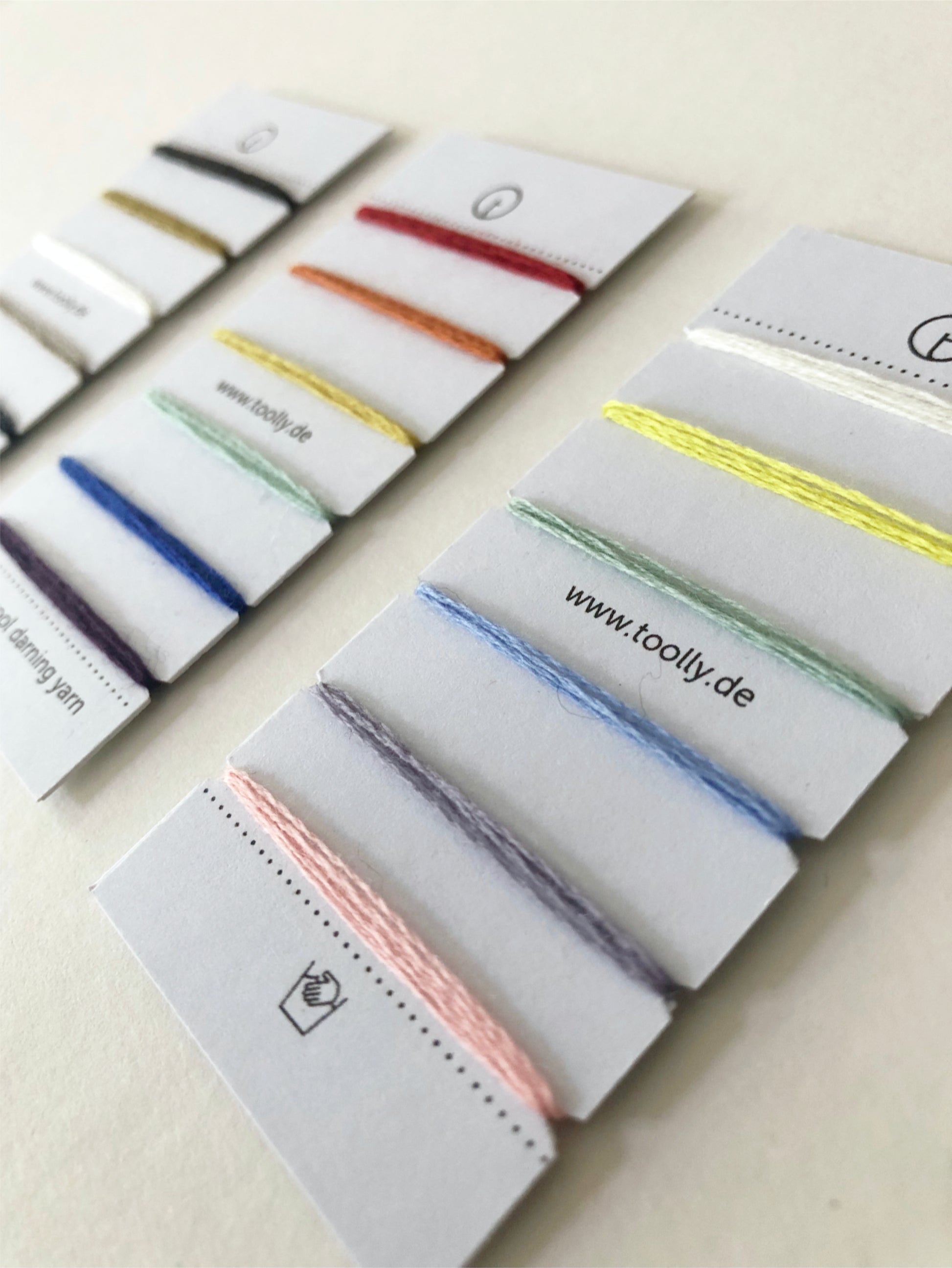 100% Wool Darning Yarn Colour Cards showing pastel, neutral, and vibrant shades for mending, embroidery, and decorative stitching.