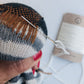 Example image of how a darning mushroom is used while repairing a big hole in a sock. There are also wool darning yarns available at toolly's online store.