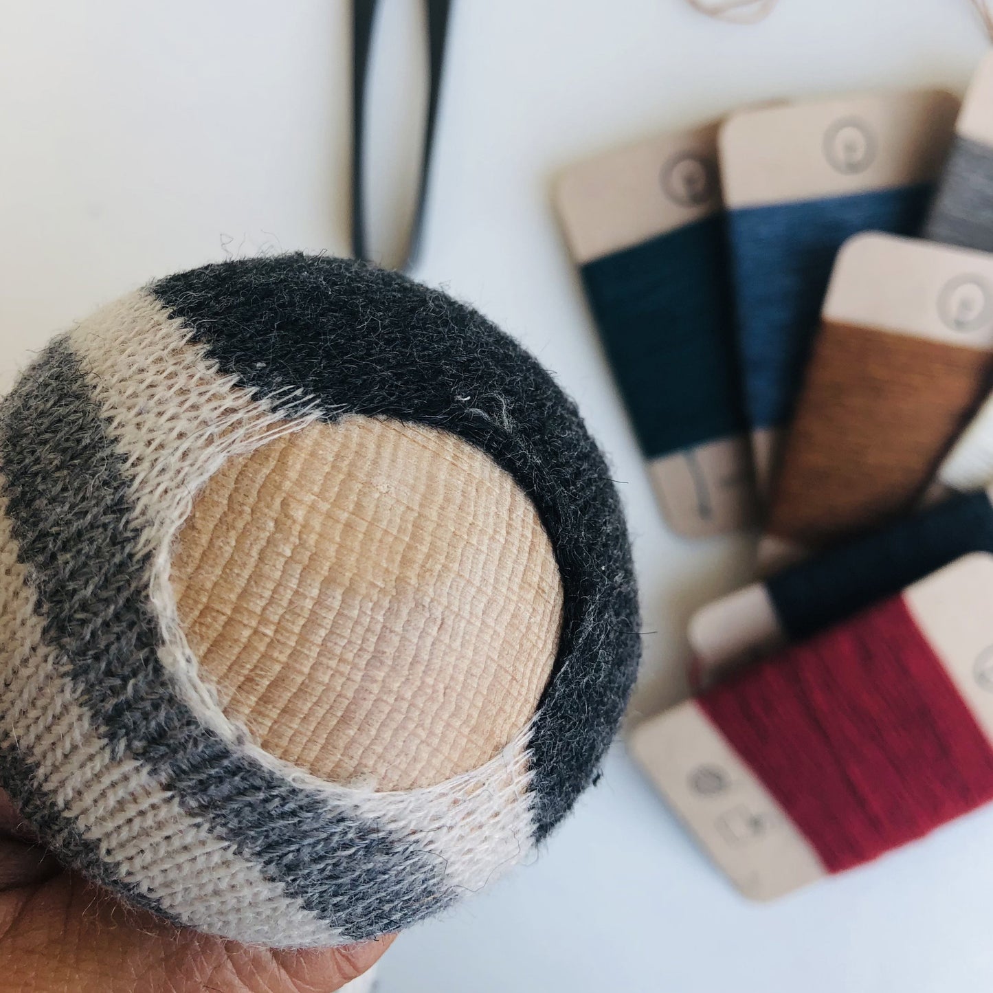 Example image of how a darning mushroom is used while repairing a big hole in a sock. There are also wool darning yarns available at toolly's online store.