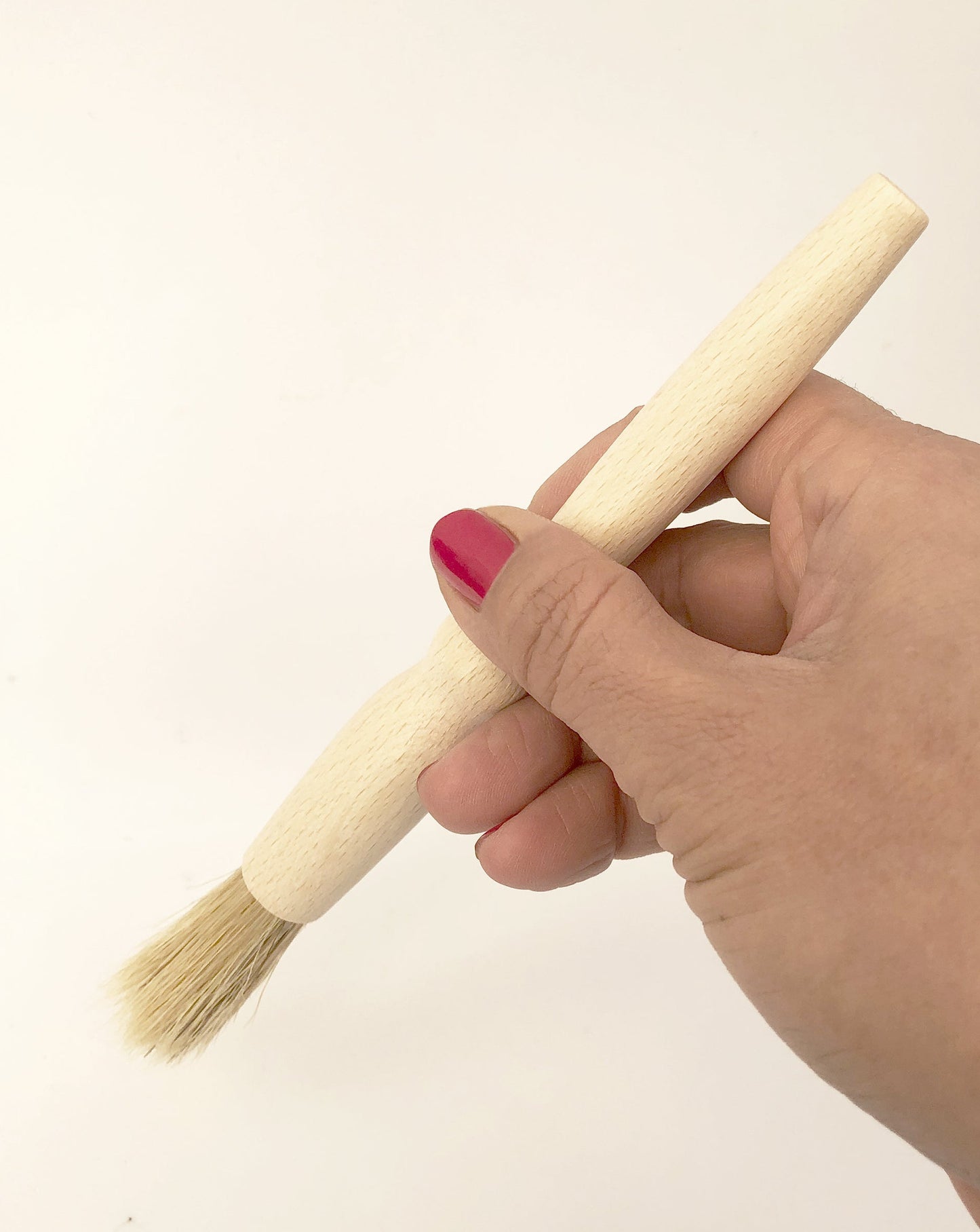 Organic shape of wood all purpose brush fits nicely in hand. Light weight, all natural and practical.