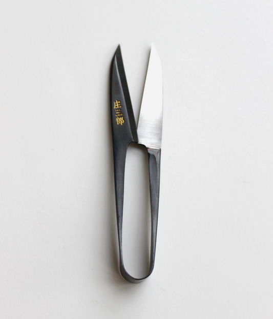Shozaburo U-shaped thread snips with long 4.5 cm carbon steel blades, designed for precision thread cutting. Compact 10.5 cm size, 30 g weight. Traditional Japanese design in paper wrap packaging, includes English care guide.